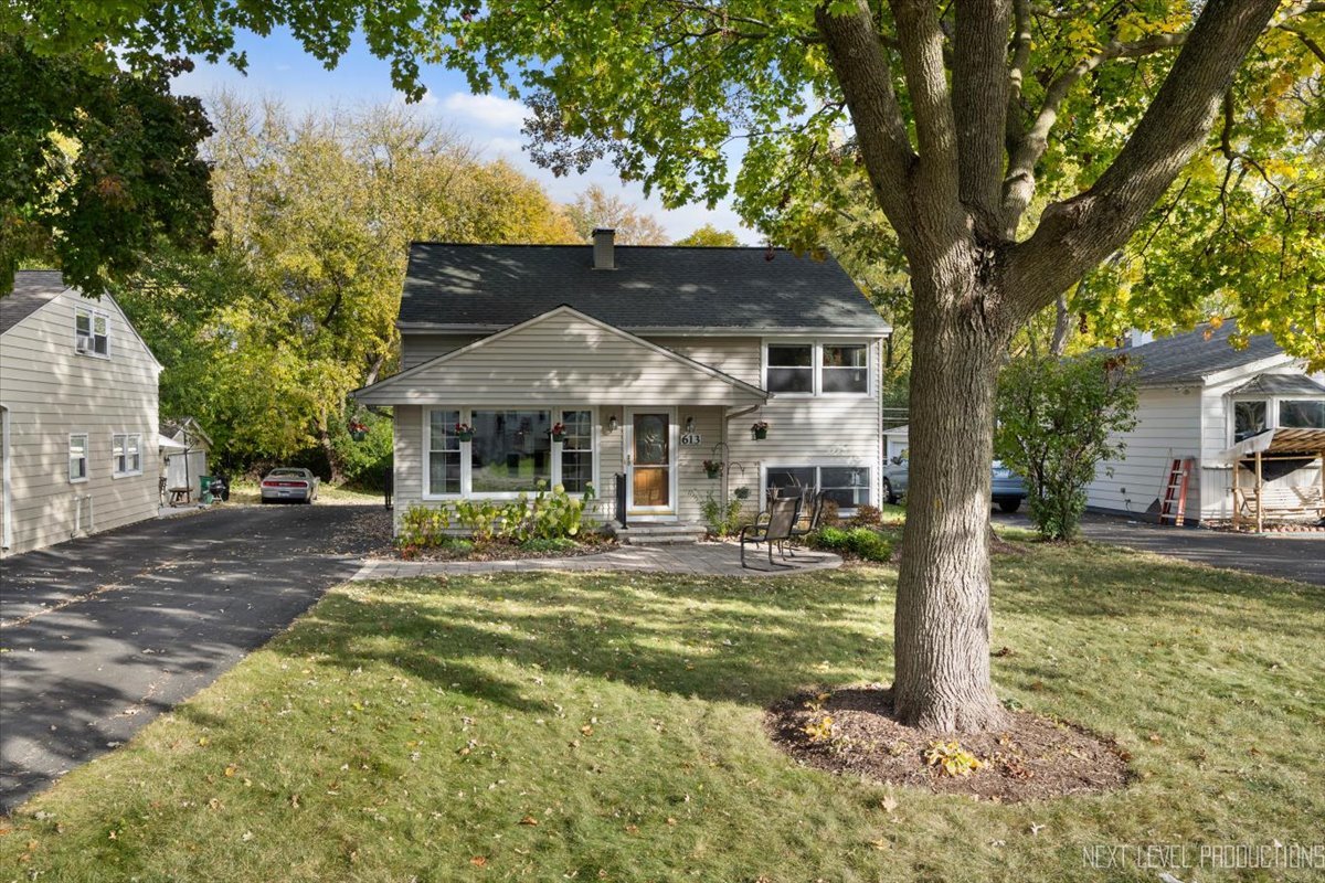 a front view of a house with swimming pool having outdoor seating