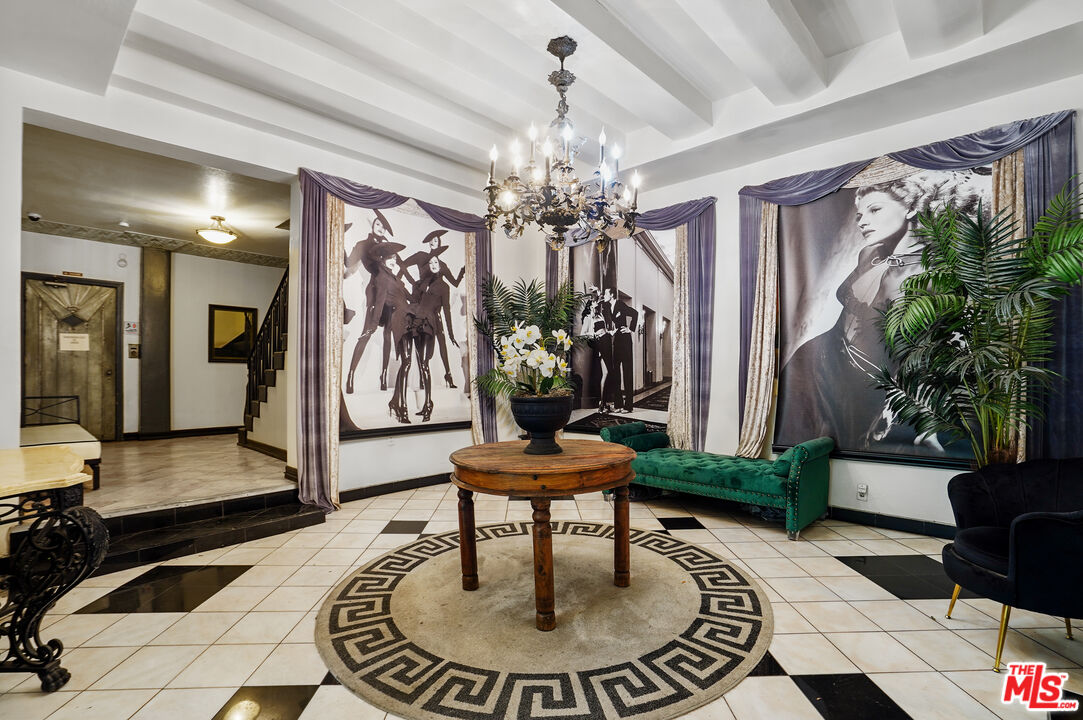 a living room with furniture and a chandelier