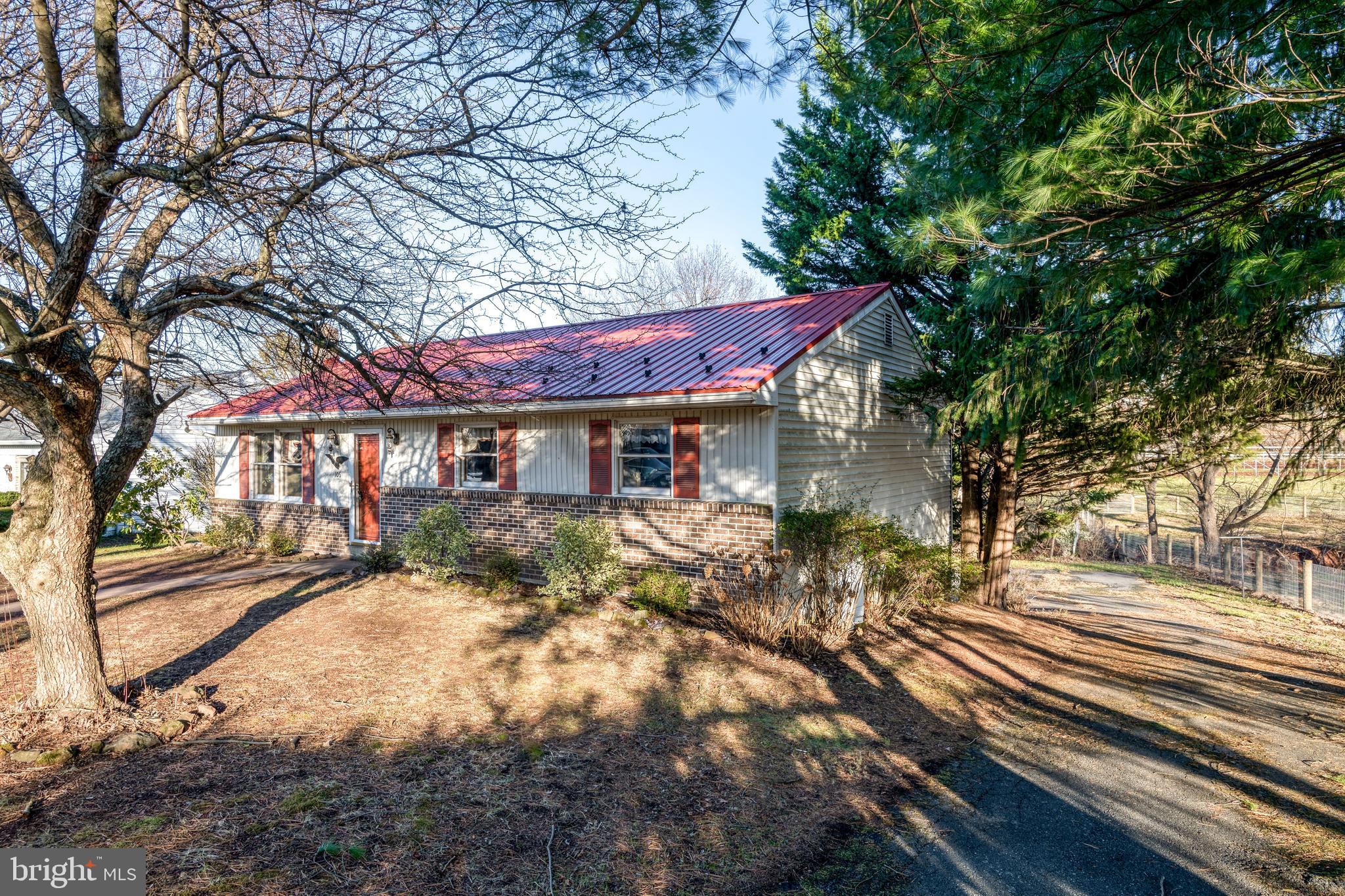 a view of a house with a tree in the yard