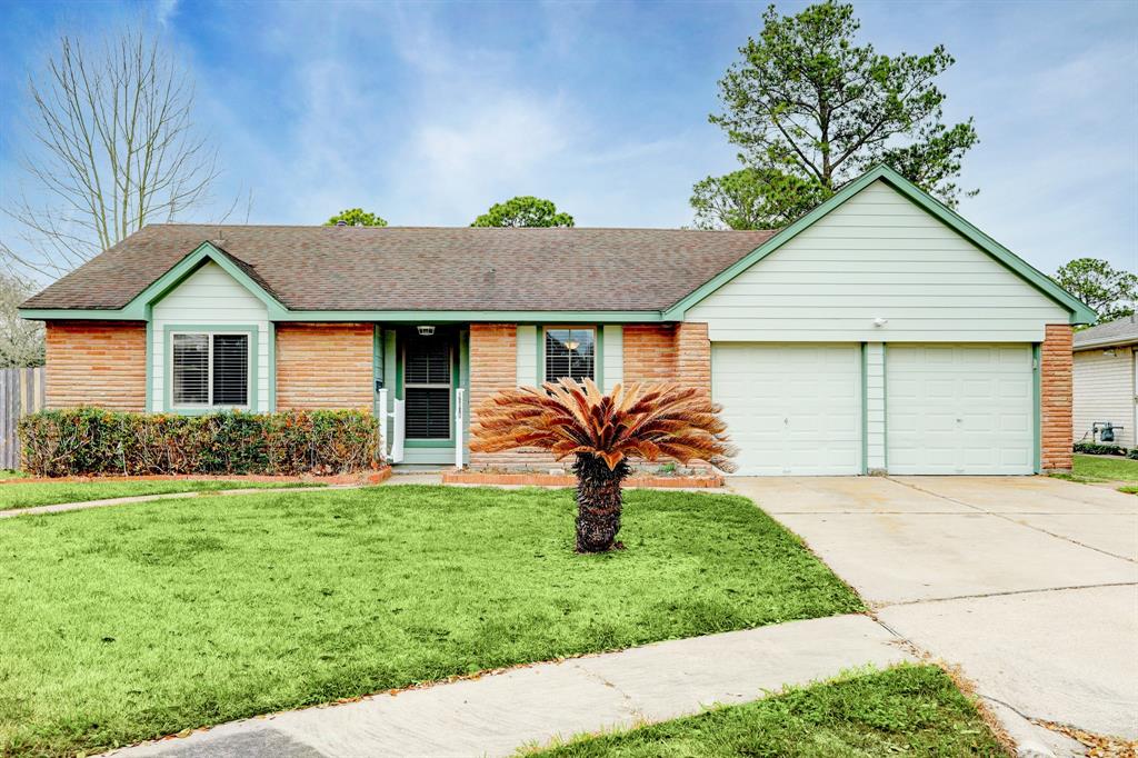 a front view of a house with a garden and yard