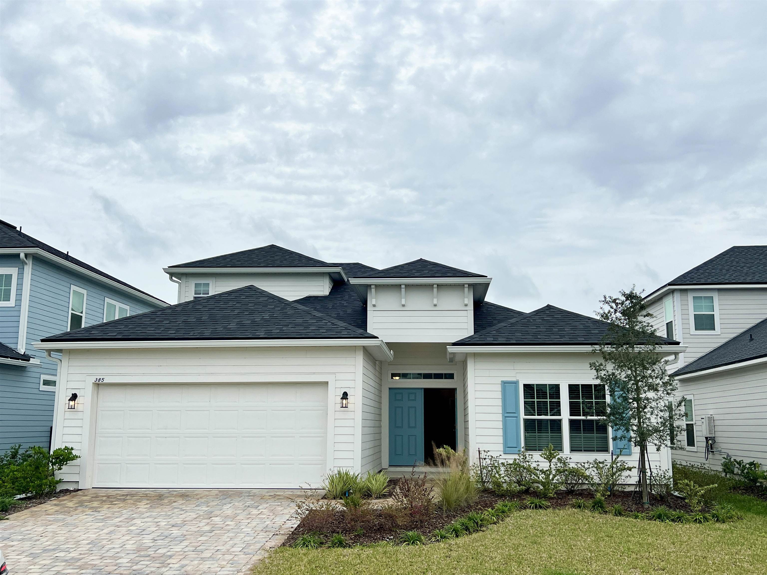 a front view of a house with a yard and garage