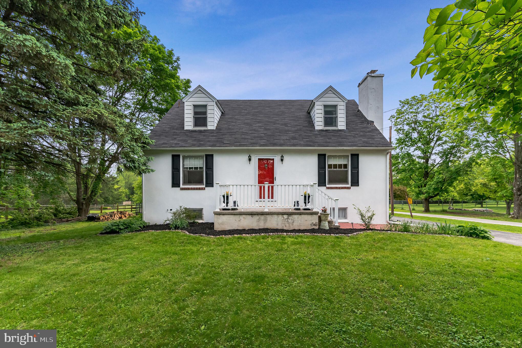 a front view of house with yard and outdoor seating