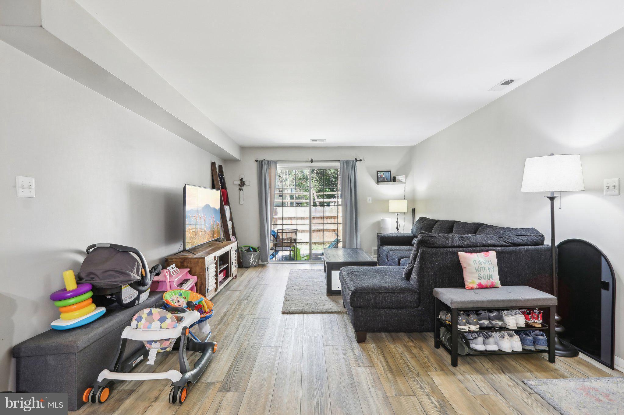 a bedroom with furniture and a wooden floor