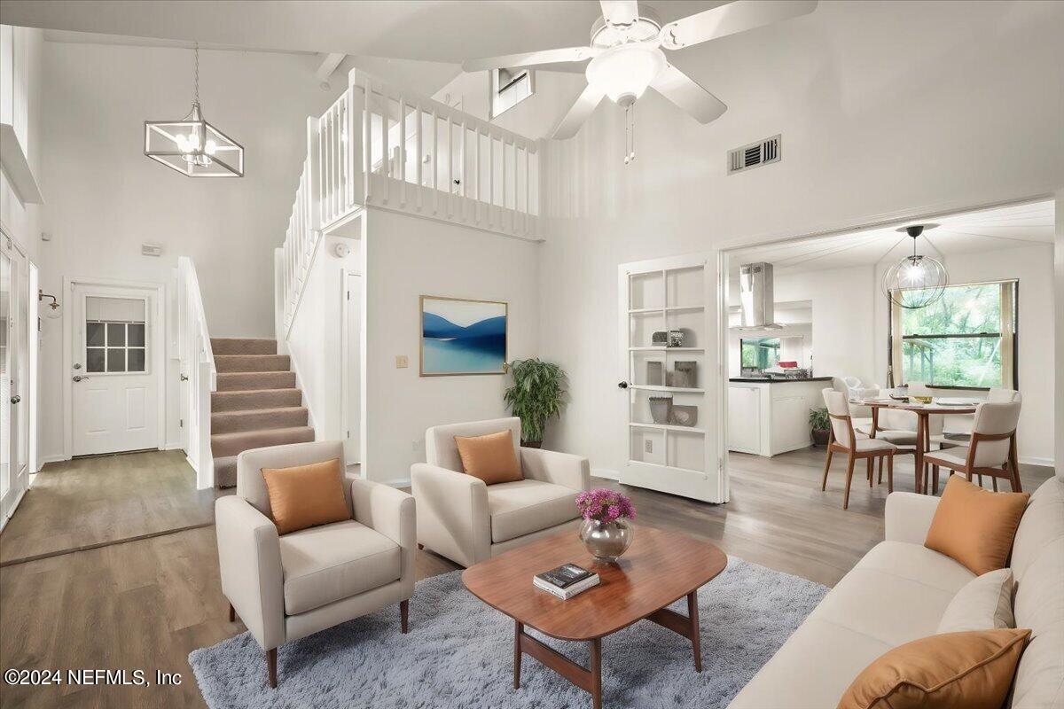 a living room with furniture a table and chairs