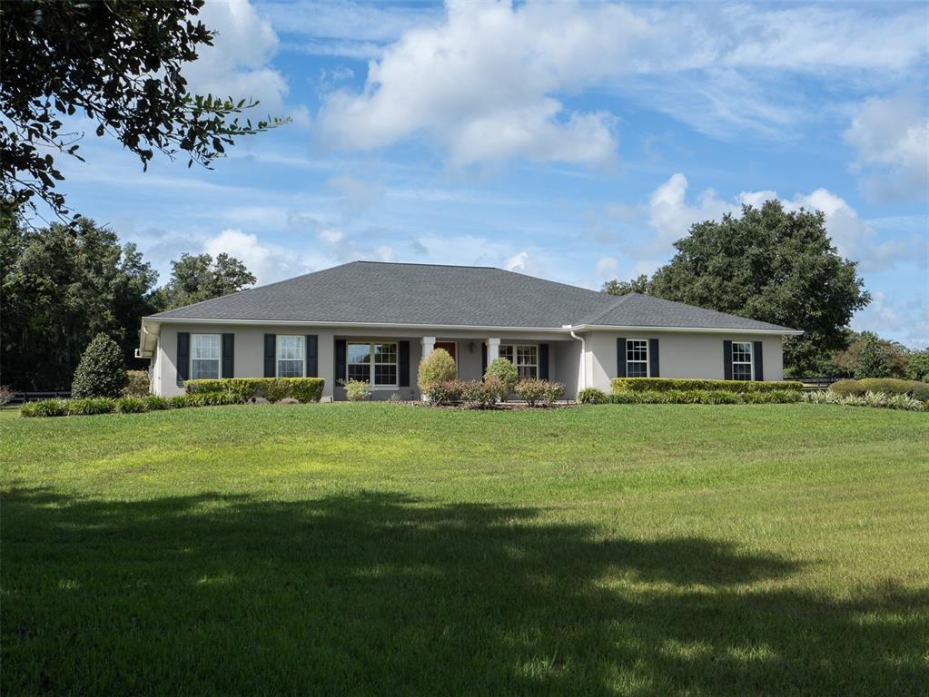 a front view of a house with a garden