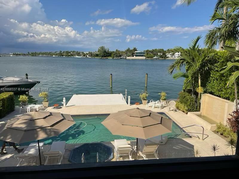 a view of a lake with couches table and chairs