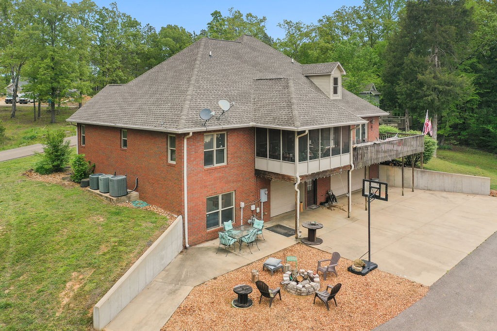 a view of a house with backyard and sitting area