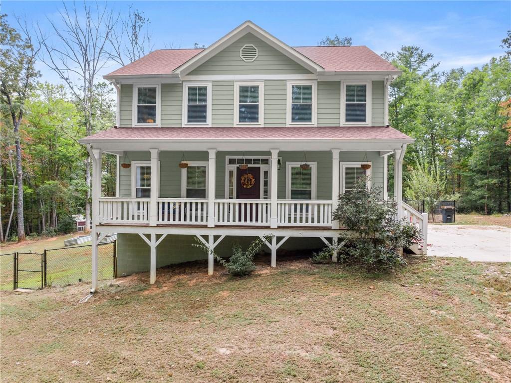 a front view of a house with plants and a yard