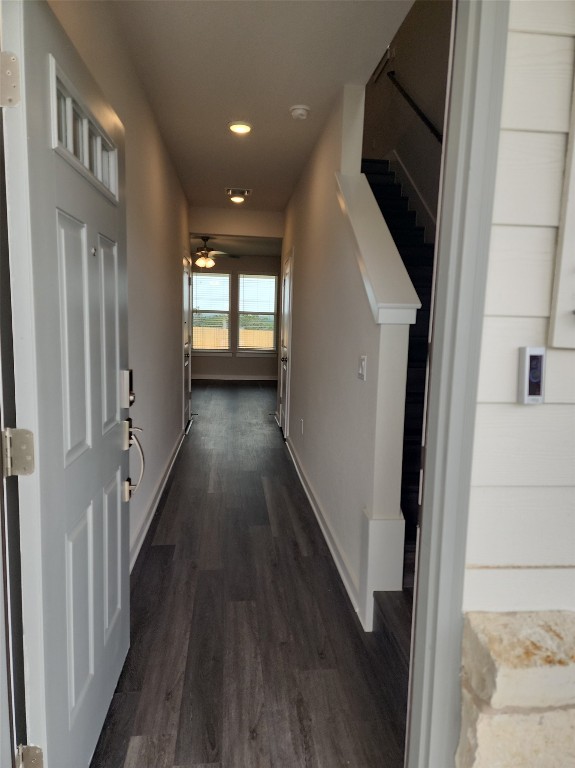 a view of a hallway with wooden floor and staircase