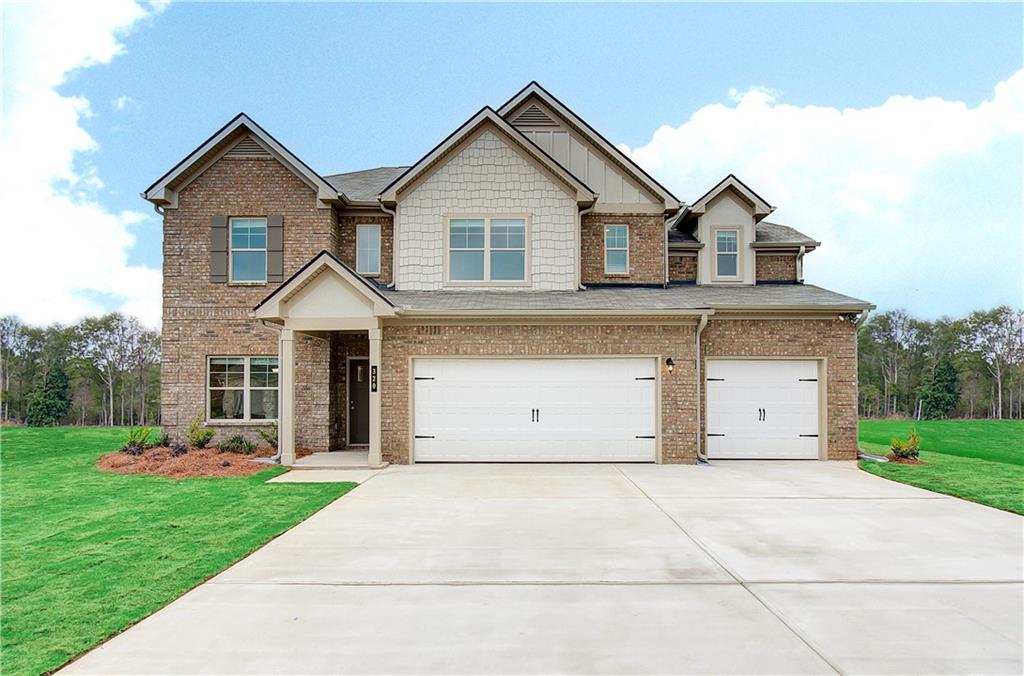 a front view of a house with a yard and garage