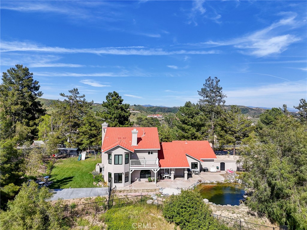 an aerial view of residential houses with outdoor space and swimming pool