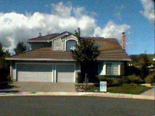 a front view of a house with a yard garage and outdoor seating