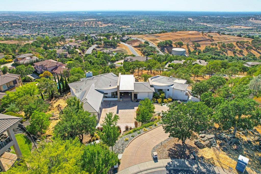 an aerial view of a house with a yard and lake view