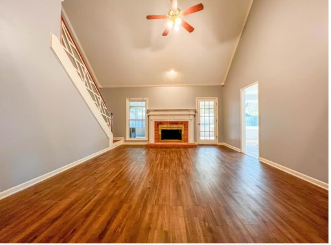 wooden floor fireplace and natural light in room