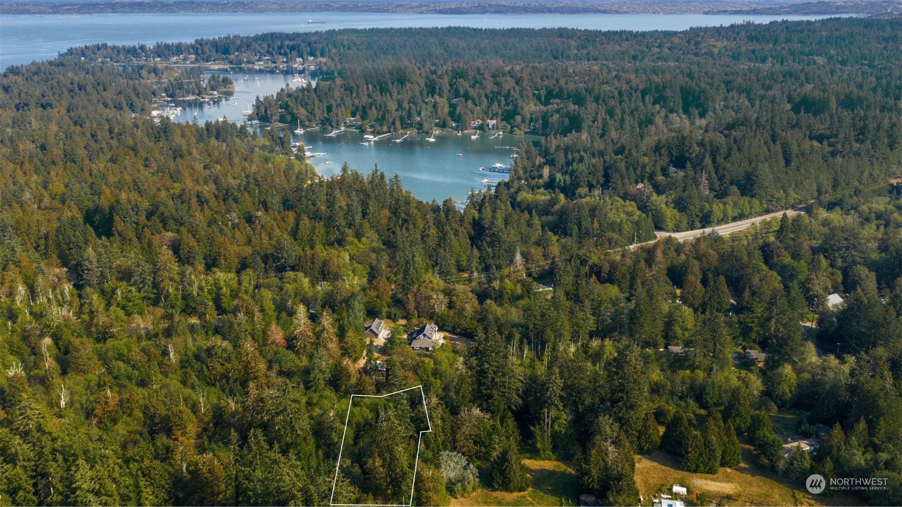 a view of a lake with green field