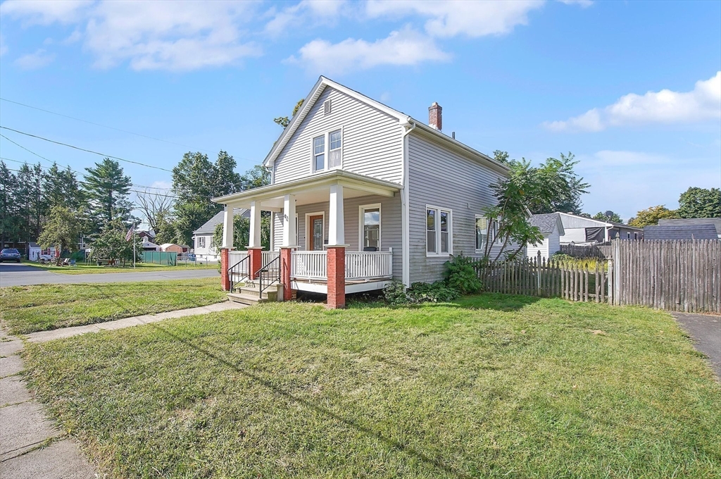 a view of a house with backyard and porch