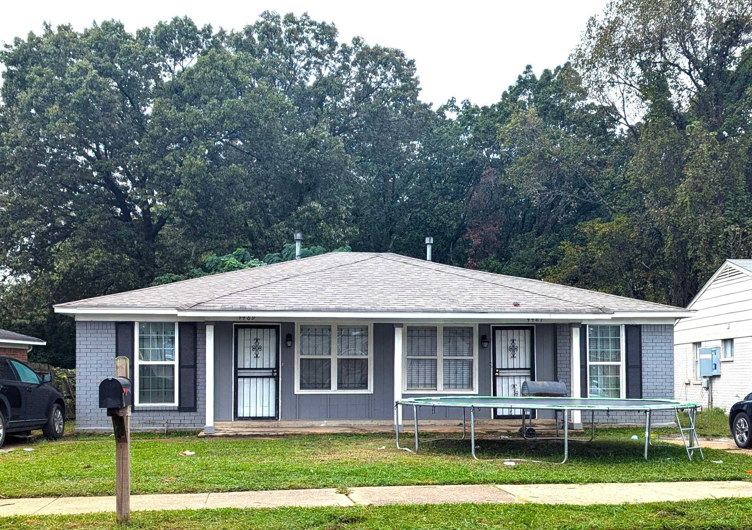 Ranch-style home featuring a trampoline and a front yard