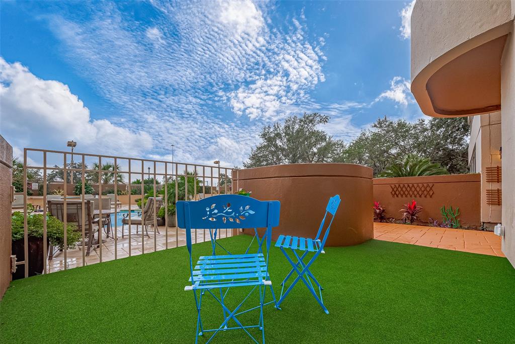 a view of a chairs and table in the patio