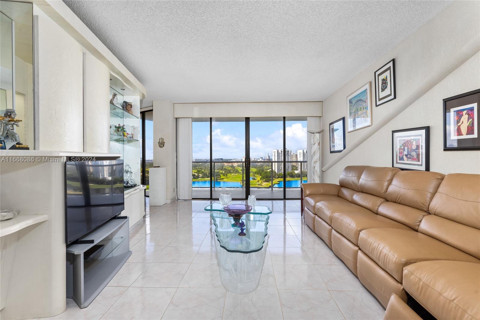 a living room with furniture ceiling fan and a rug