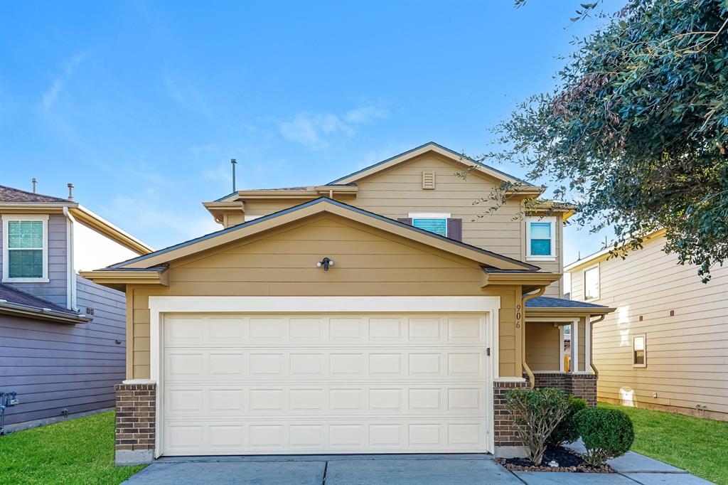 a front view of a house with garage