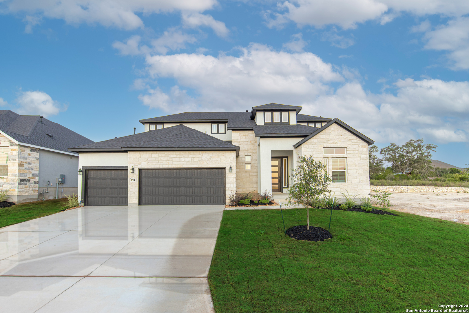 a front view of a house with a yard and garage