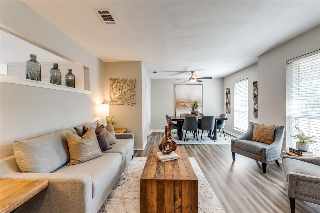 a living room with furniture and wooden floor