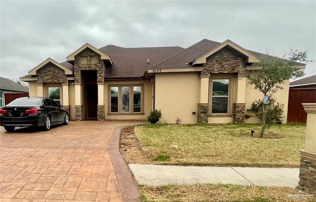 a front view of a house with a yard outdoor seating and garage