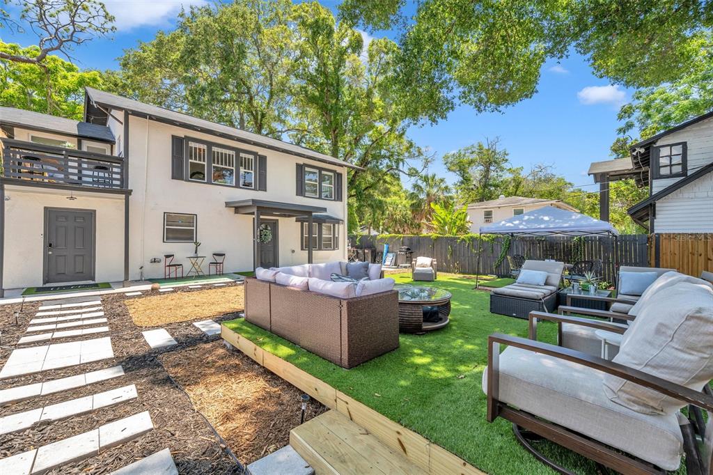 a view of an house with backyard and furniture