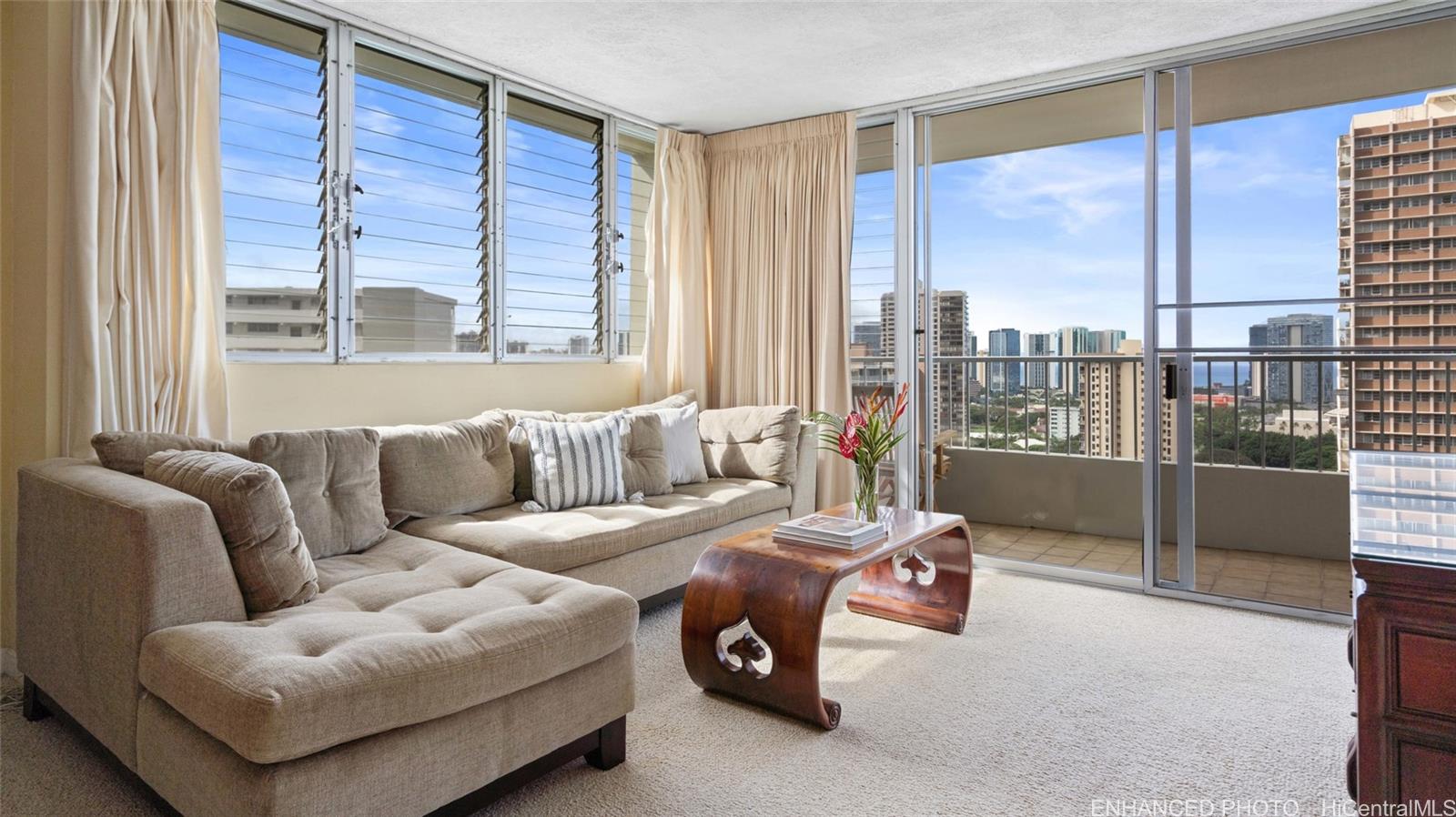 a living room with furniture and a floor to ceiling window