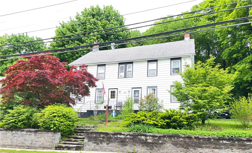 a aerial view of a house with a yard and potted plants