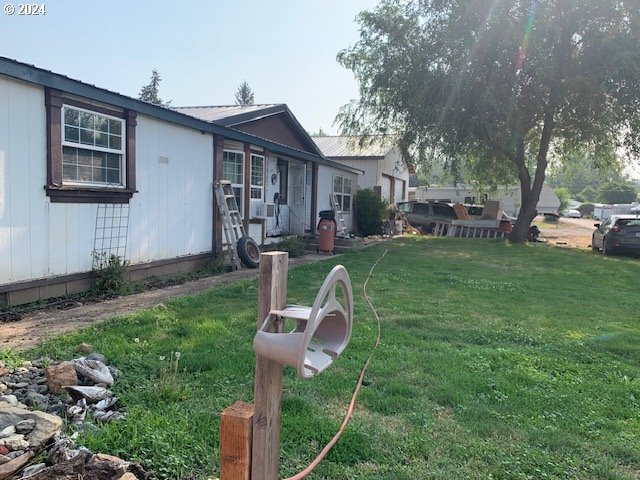 a view of a house with a yard porch and sitting area