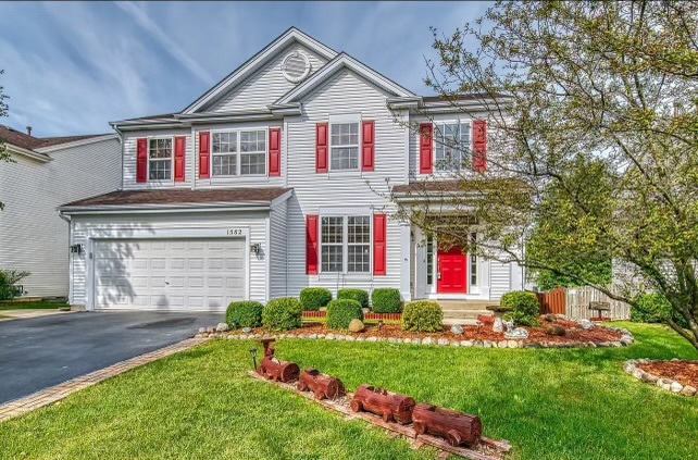 a front view of a house with a yard and garage