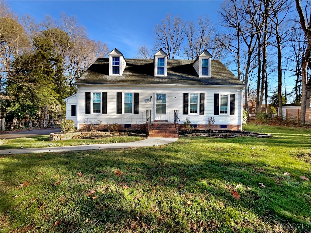 a front view of house with yard outdoor seating and green space