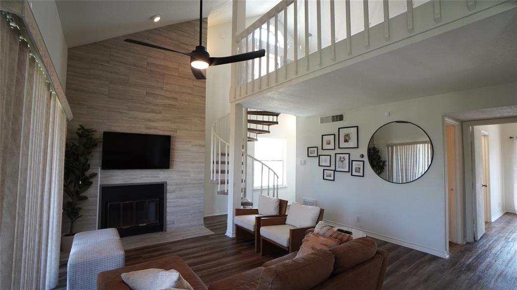 a living room with furniture a fireplace and a flat screen tv