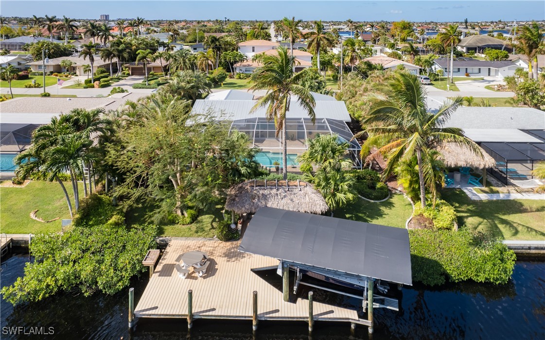 an aerial view of a house with a yard wooden table and chairs