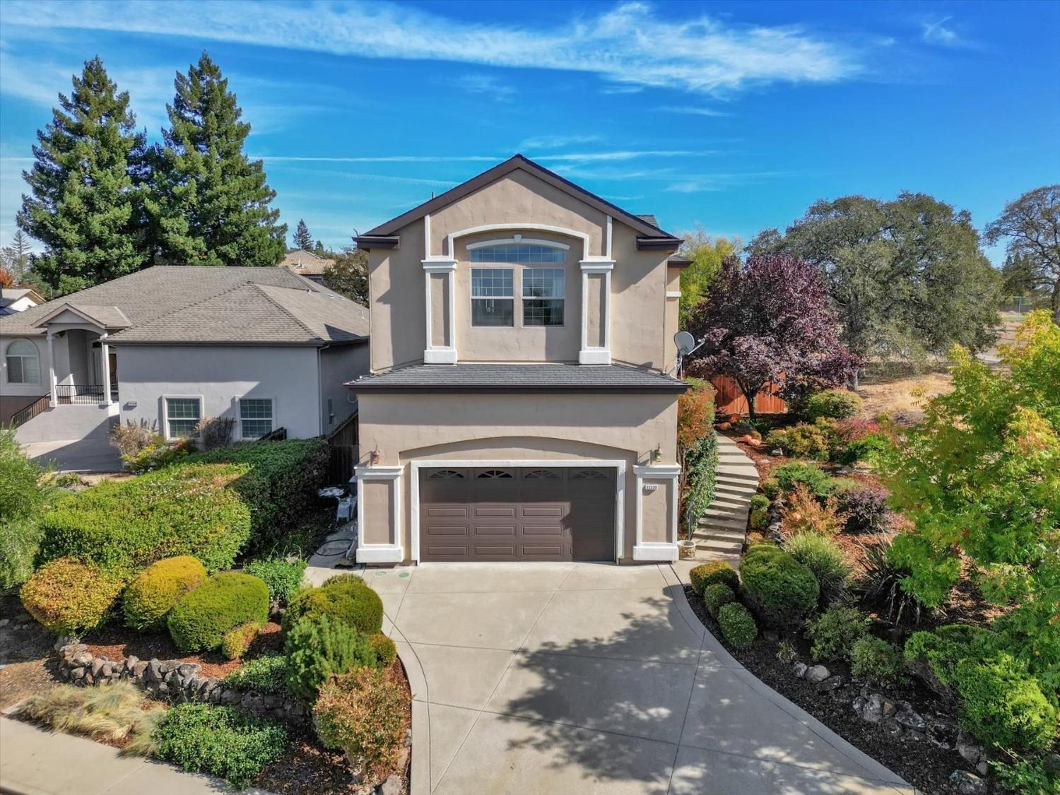 a front view of a house with a garden