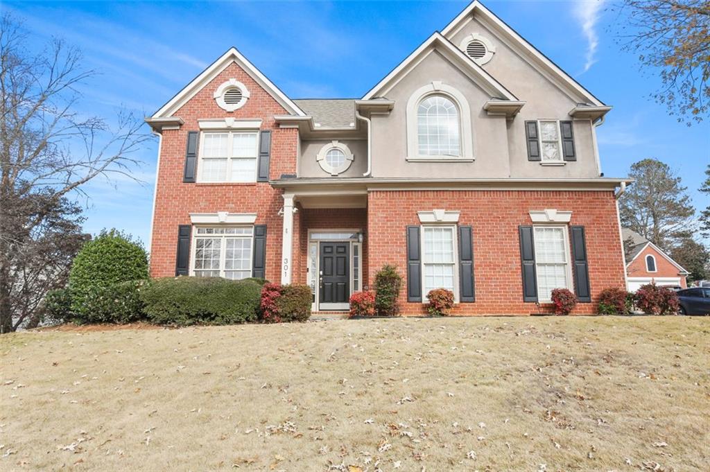 a front view of a house with a yard