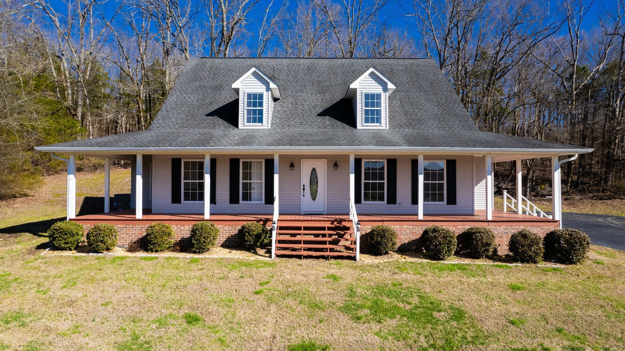 a front view of a house with yard and seating space