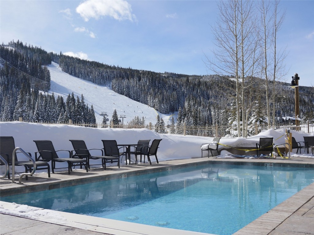 a view of a swimming pool with outdoor seating