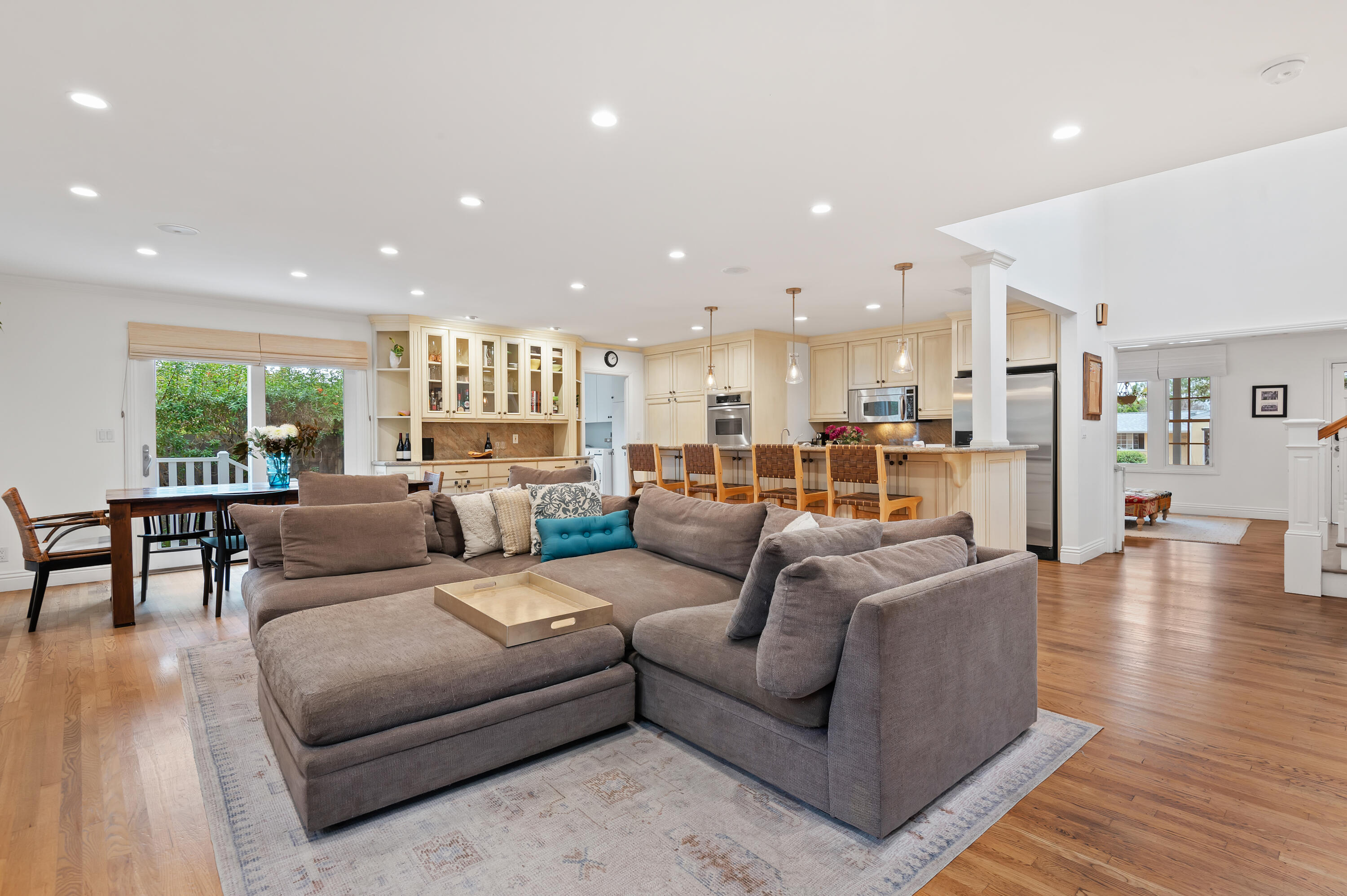 a living room with furniture and a wooden floor