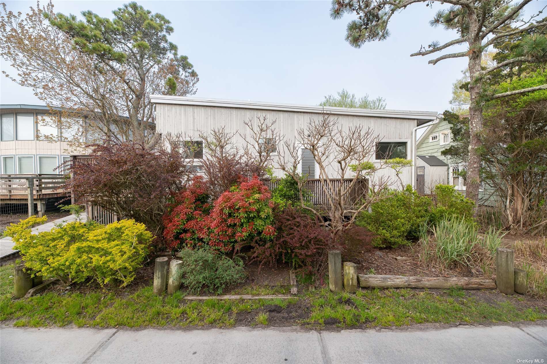 a front view of a house with a yard and a garden