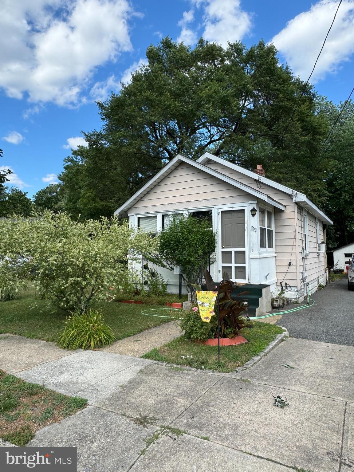 a view of a house with backyard sitting area and garden