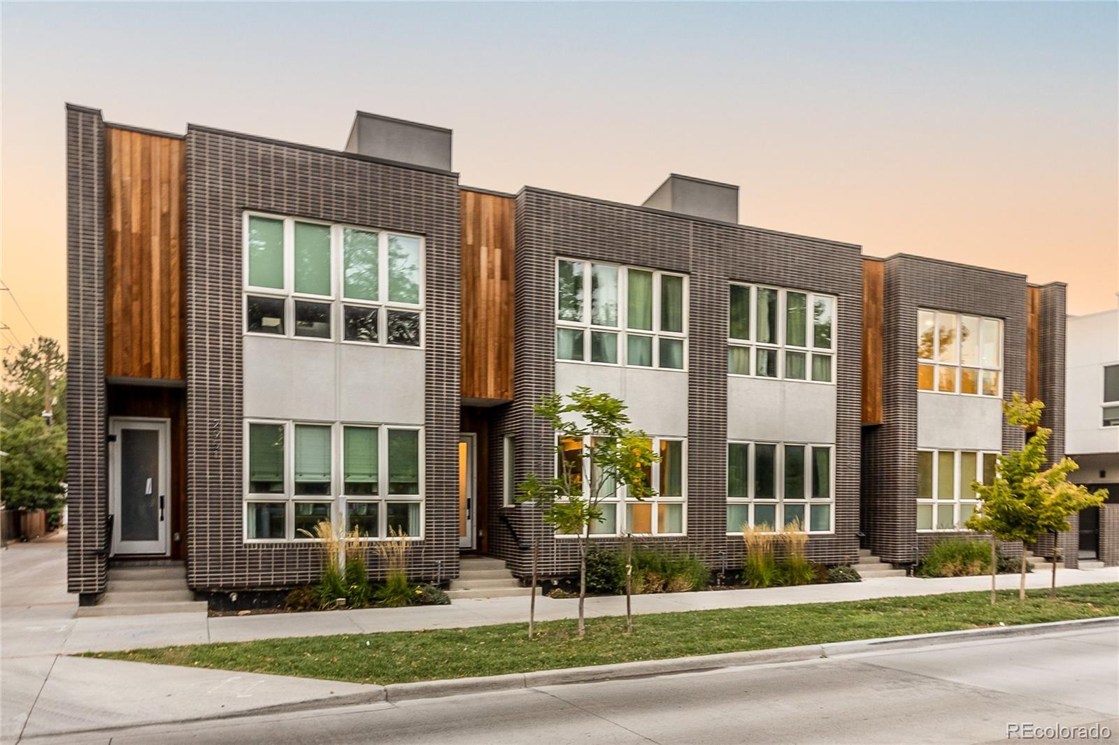 a front view of a residential apartment building with a yard