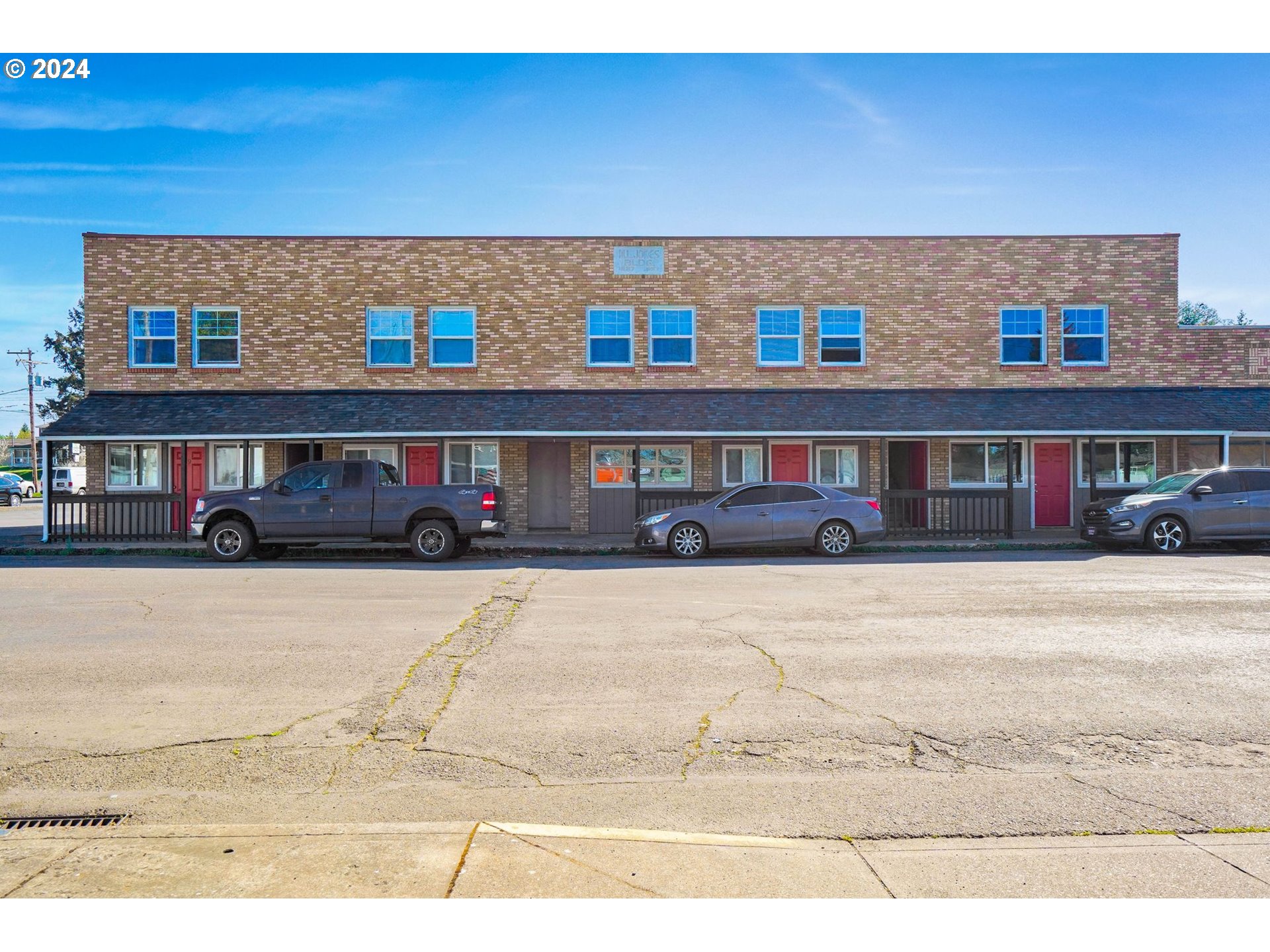 a front view of a building with parking space