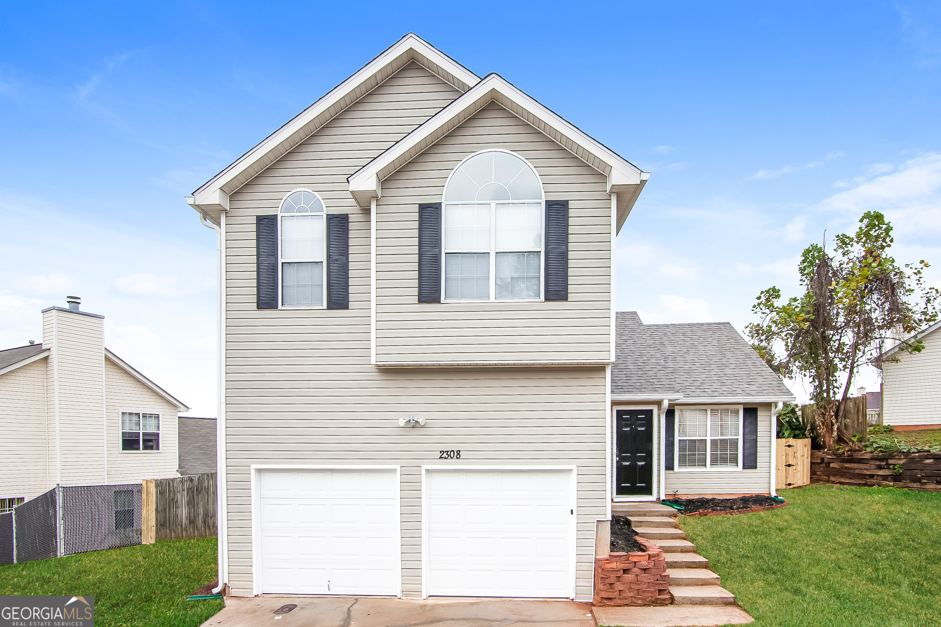 a front view of a house with a yard