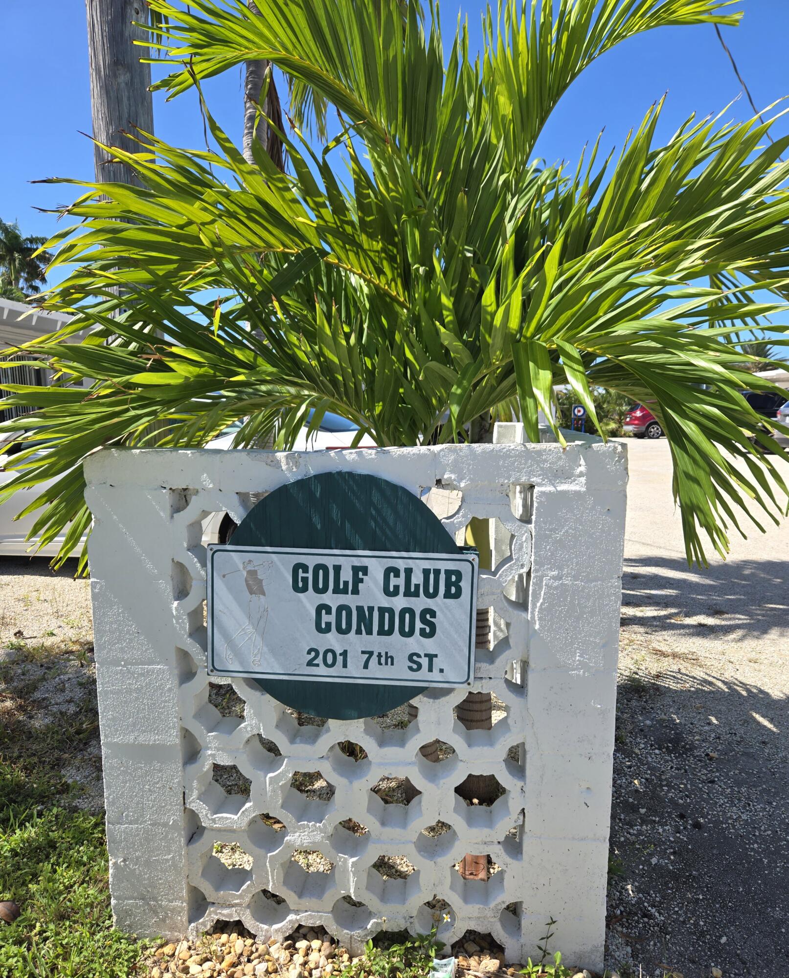 a sign on a road next to a building