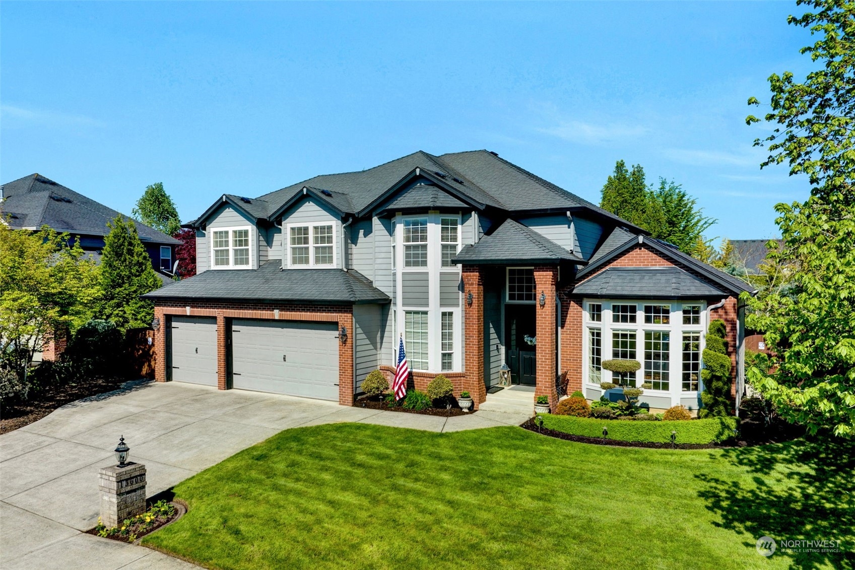 a front view of a house with a garden and plants