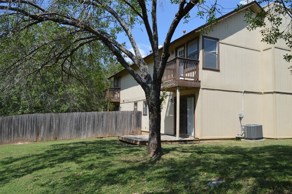 a view of a backyard with large tree