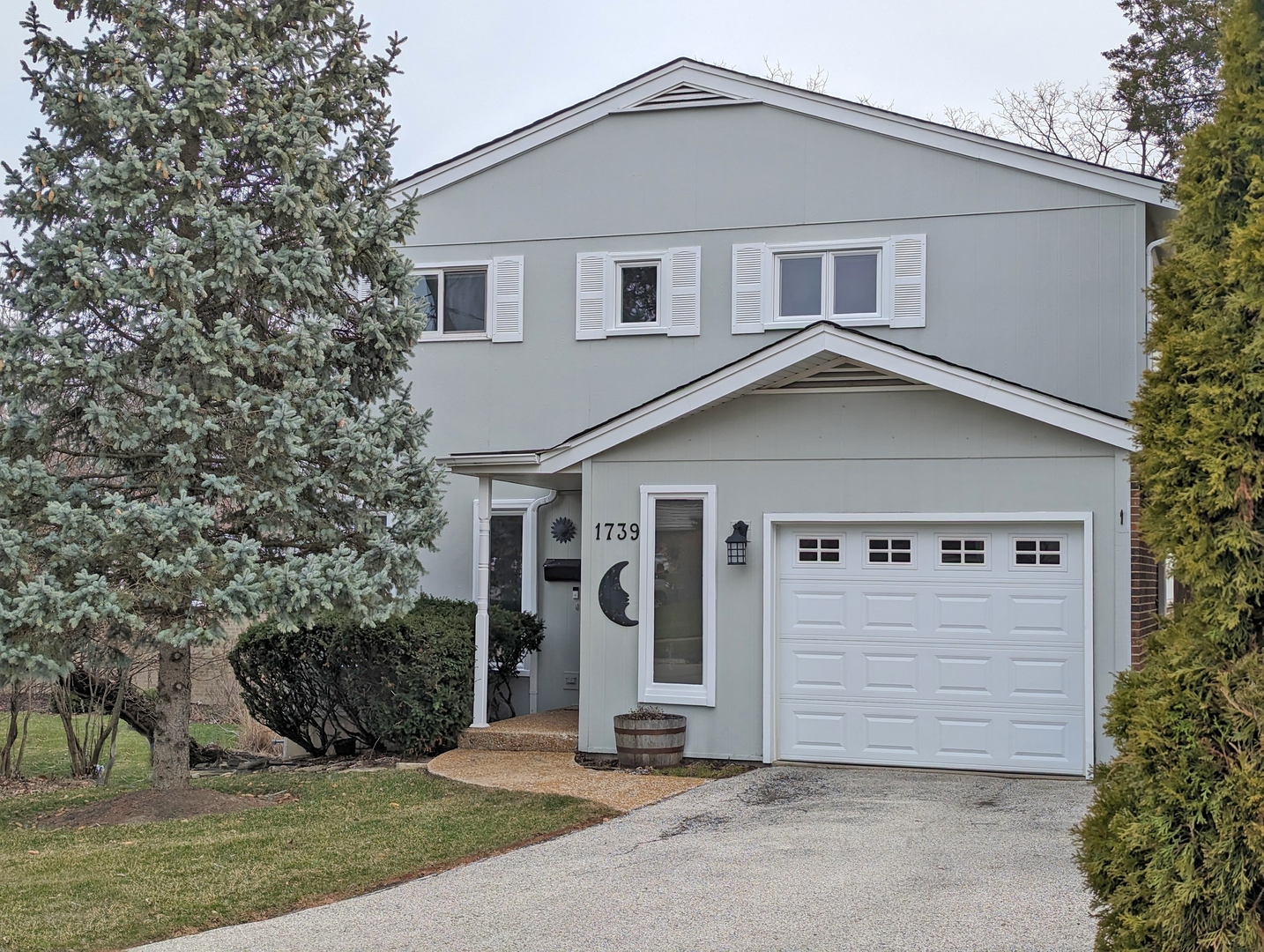 a front view of a house with garage