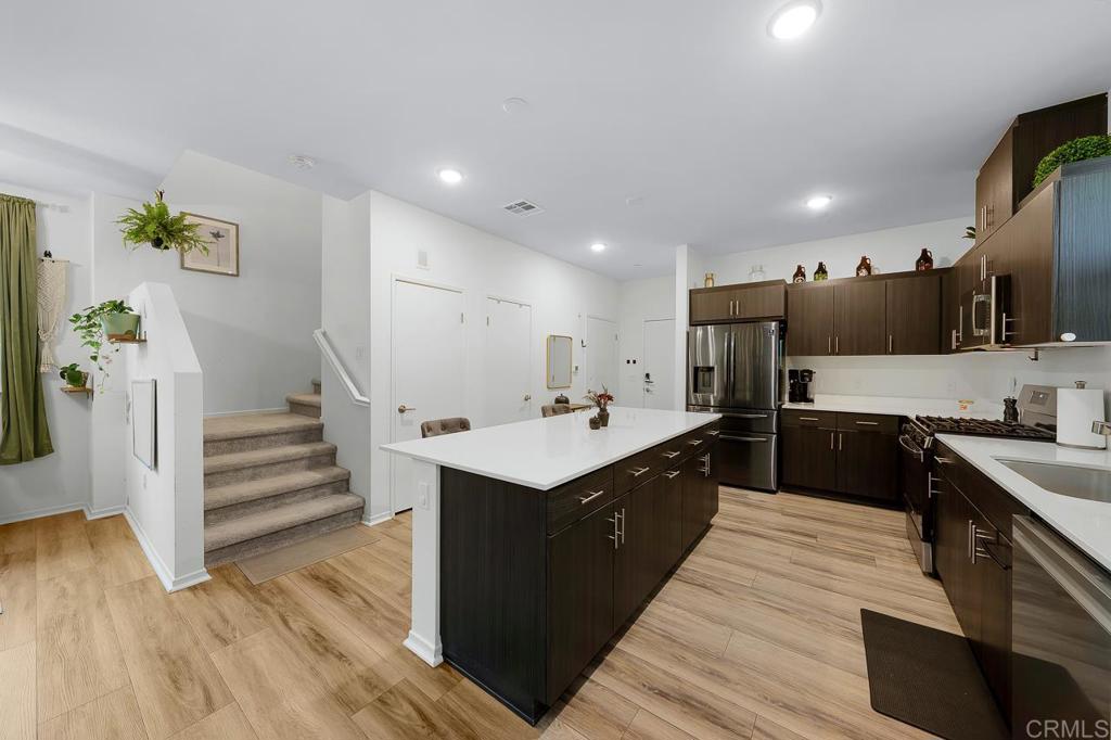 a kitchen with stainless steel appliances sink stove microwave and cabinets